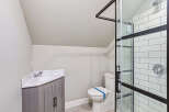 Step into this beautifully designed bathroom, featuring a modern vanity and a sleek shower enclosure.