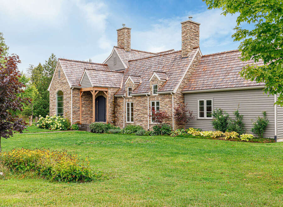 This stunning stone and wood-clad home exudes timeless elegance and charm.