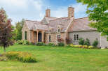 This stunning stone and wood-clad home exudes timeless elegance and charm.