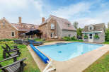 This stunning property boasts a luxurious outdoor oasis, perfect for relaxation and entertainment.