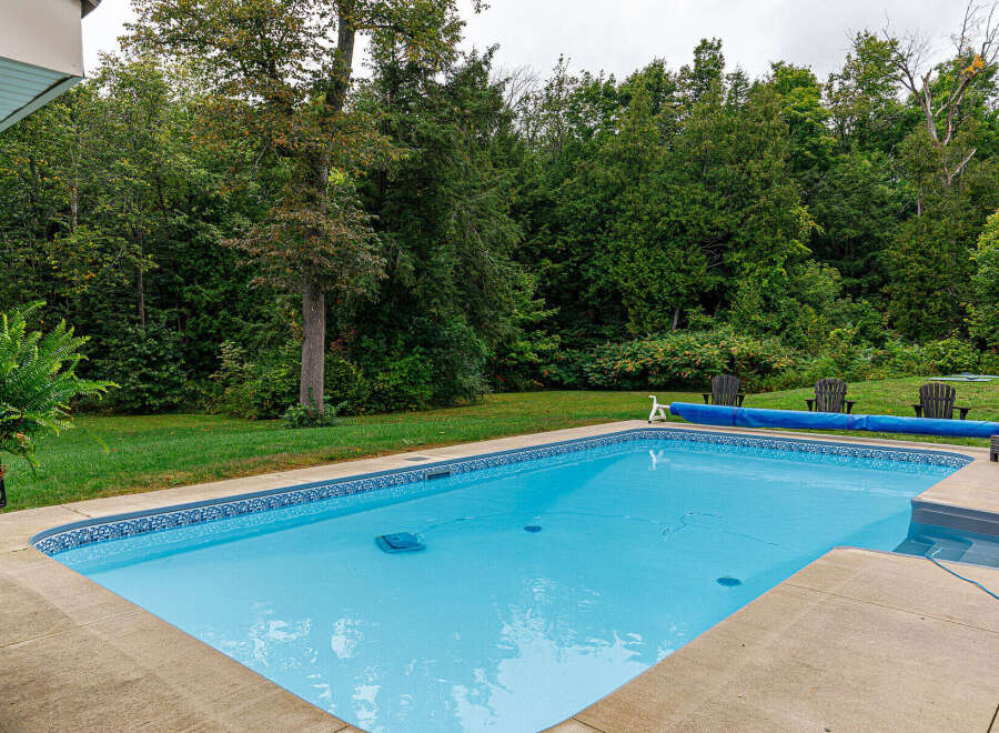 Enjoy the tranquility of this stunning property featuring a sparkling swimming pool, perfect for relaxation and entertainment.