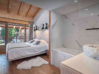 Experience luxury living in this stunning property, featuring a beautifully designed bedroom with a cozy bed and a stylish bathroom.