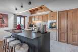 This stunning kitchen boasts a modern design with a sleek island and ample counter space, perfect for culinary enthusiasts.