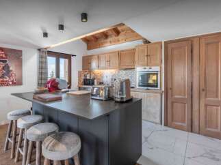 This stunning kitchen boasts a modern design with a sleek island and ample counter space, perfect for culinary enthusiasts.