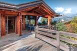 Experience luxury living in this stunning wooden chalet, boasting a spacious deck and breathtaking mountain views.
