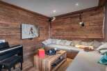 Experience the warmth of this stunning living space, featuring exquisite wood paneling and a cozy, inviting atmosphere.