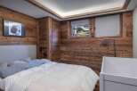 This cozy bedroom features stunning wood paneling, creating a warm and inviting atmosphere.