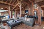 Experience rustic luxury in this stunning chalet, featuring exposed wooden beams and a warm, inviting atmosphere.