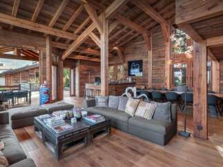 Experience rustic luxury in this stunning chalet, featuring exposed wooden beams and a warm, inviting atmosphere.
