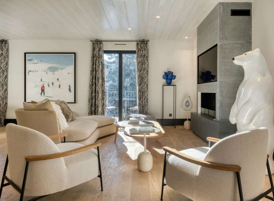 Experience luxury living in this stunning property, featuring a modern living room with a cozy fireplace and elegant decor.
