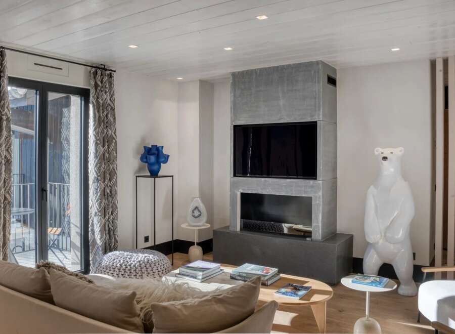 This stunning living room boasts a modern fireplace and a large flat-screen TV, perfect for cozy evenings.