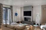 This stunning living room boasts a modern fireplace and a large flat-screen TV, perfect for cozy evenings.