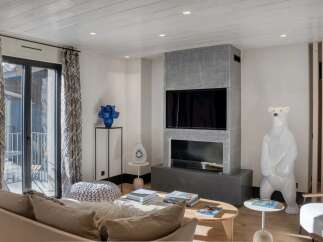 This stunning living room boasts a modern fireplace and a large flat-screen TV, perfect for cozy evenings.