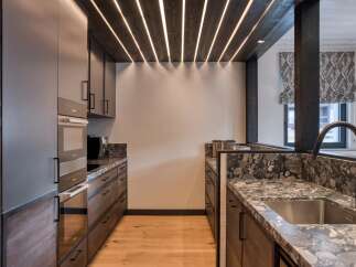 Experience luxury living in this stunning kitchen! Featuring sleek cabinetry, modern appliances, and a beautiful countertop, this space is perfect for both cooking and entertaining.