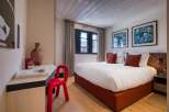 Experience luxury in this exquisite bedroom, featuring a comfortable bed and stylish decor.
