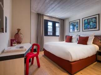Experience luxury in this exquisite bedroom, featuring a comfortable bed and stylish decor.