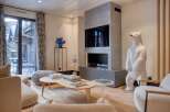 Experience luxury living in this stunning property, featuring a modern fireplace and a unique polar bear sculpture.