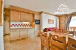 Discover the charm of this cozy property, featuring a well-equipped kitchen with wooden cabinetry and a stylish backsplash.