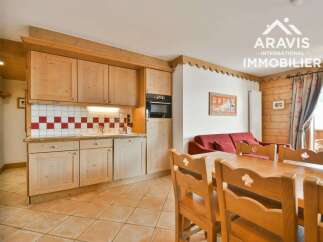 Discover the charm of this cozy property, featuring a well-equipped kitchen with wooden cabinetry and a stylish backsplash.