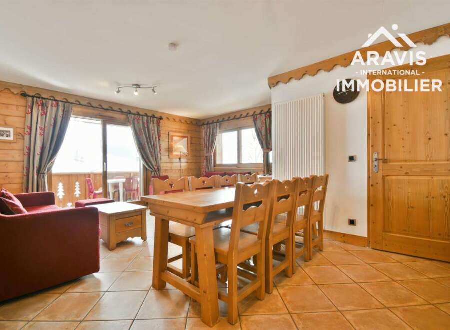 Discover the charm of this inviting property, featuring a cozy living space with wooden accents and a dining area perfect for gatherings.