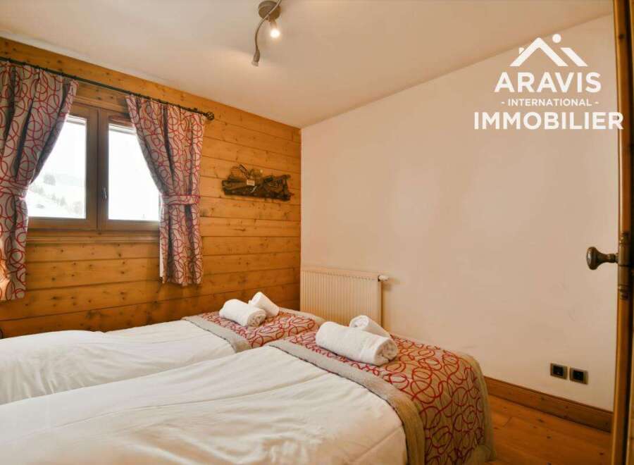 Discover the charm of this cozy bedroom featuring two comfortable beds, perfect for a relaxing stay.