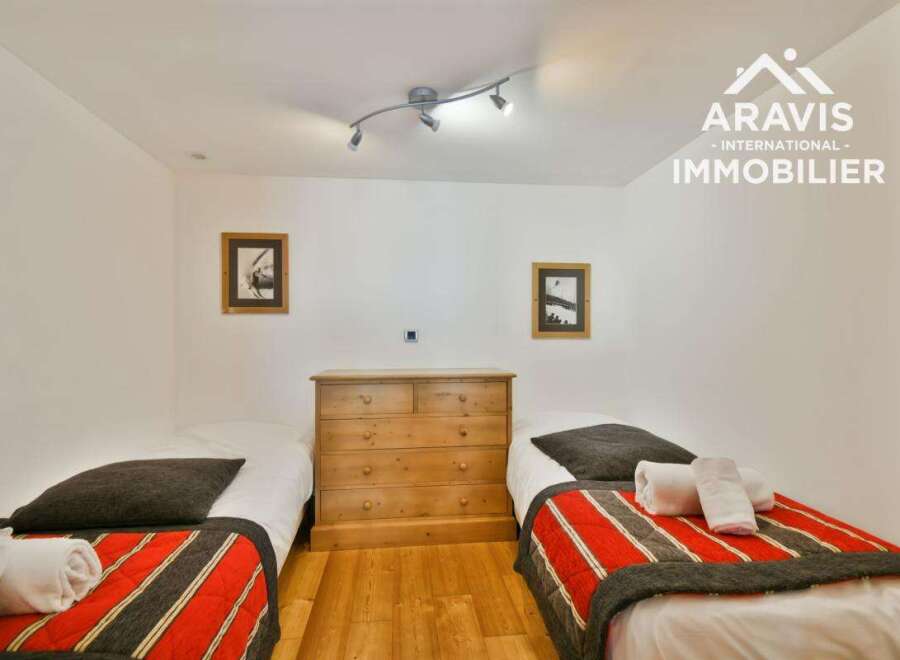 Discover this charming bedroom featuring two cozy single beds, perfect for a comfortable stay.