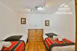 Discover this charming bedroom featuring two cozy single beds, perfect for a comfortable stay.
