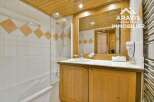 Discover the charm of this bathroom, featuring a stylish wooden vanity and a sleek glass shower enclosure.