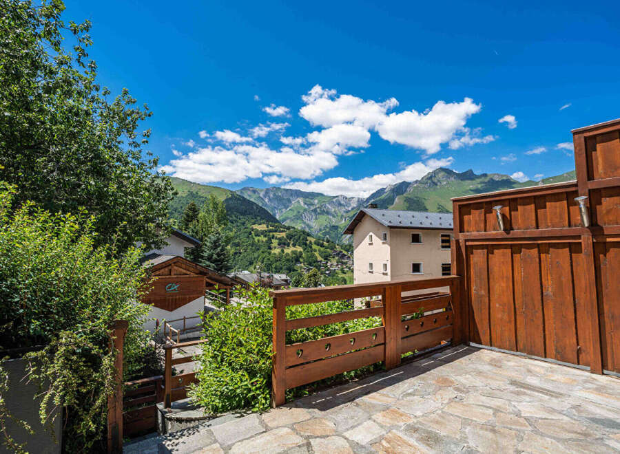 Experience breathtaking mountain views from this charming property, featuring a spacious wooden deck perfect for outdoor relaxation.