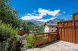 Experience breathtaking mountain views from this charming property, featuring a spacious wooden deck perfect for outdoor relaxation.