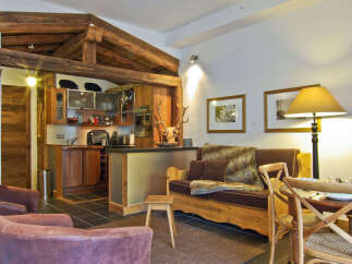 This charming property features a rustic kitchen with wooden cabinetry and exposed beams, creating a warm and inviting atmosphere.