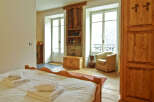 This charming bedroom boasts a cozy ambiance with its wooden accents and inviting decor.
