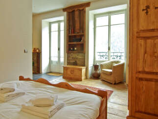 This charming bedroom boasts a cozy ambiance with its wooden accents and inviting decor.