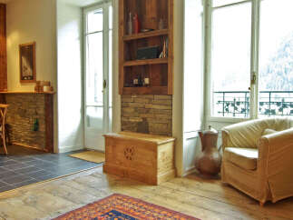 This charming property boasts a rustic interior with exposed wooden beams and stone accents, creating a warm and inviting atmosphere.