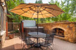 Enjoy outdoor living at its finest with this stunning patio featuring a luxurious hot tub and a cozy fireplace.