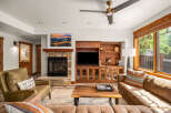 Step into luxury with this stunning living room, featuring a cozy fireplace and a sleek entertainment center.