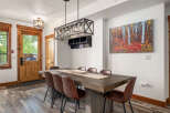 This stunning dining room features a rustic wooden table, perfect for hosting gatherings.
