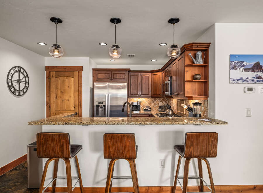 This stunning kitchen boasts a modern design with sleek stainless steel appliances and beautiful wooden cabinetry.
