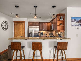 This stunning kitchen boasts a modern design with sleek stainless steel appliances and beautiful wooden cabinetry.
