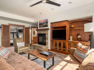 This stunning living space boasts a cozy fireplace, perfect for chilly evenings.