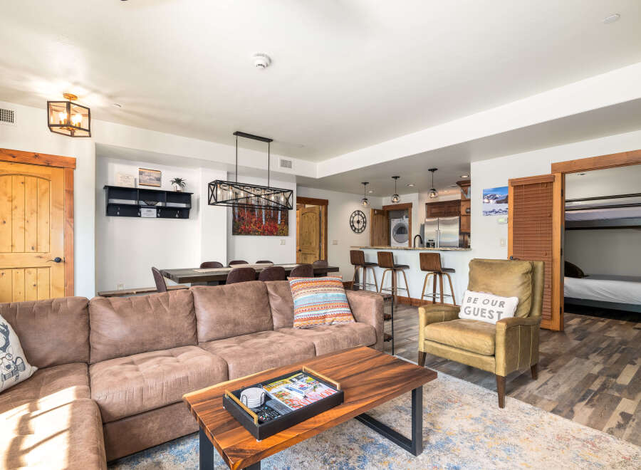 This stunning property boasts a spacious living area with a comfortable sectional sofa and a stylish coffee table.