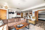 This stunning property boasts a spacious living area with a comfortable sectional sofa and a stylish coffee table.