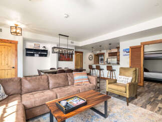 This stunning property boasts a spacious living area with a comfortable sectional sofa and a stylish coffee table.