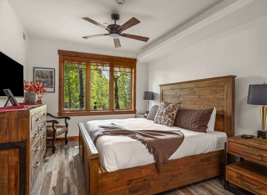 This stunning bedroom boasts a rustic charm with its wooden furniture and inviting ambiance.