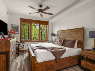 This stunning bedroom boasts a rustic charm with its wooden furniture and inviting ambiance.