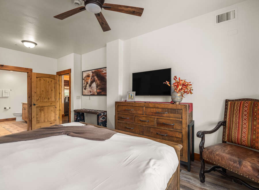 This stunning bedroom boasts a rustic charm with its wooden furniture and inviting ambiance.