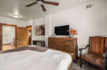 This stunning bedroom boasts a rustic charm with its wooden furniture and inviting ambiance.