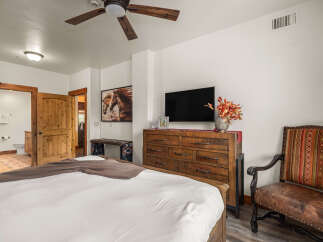 This stunning bedroom boasts a rustic charm with its wooden furniture and inviting ambiance.