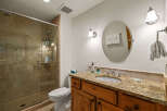 This stunning bathroom features a luxurious granite countertop and a stylish vanity, creating an elegant and functional space.