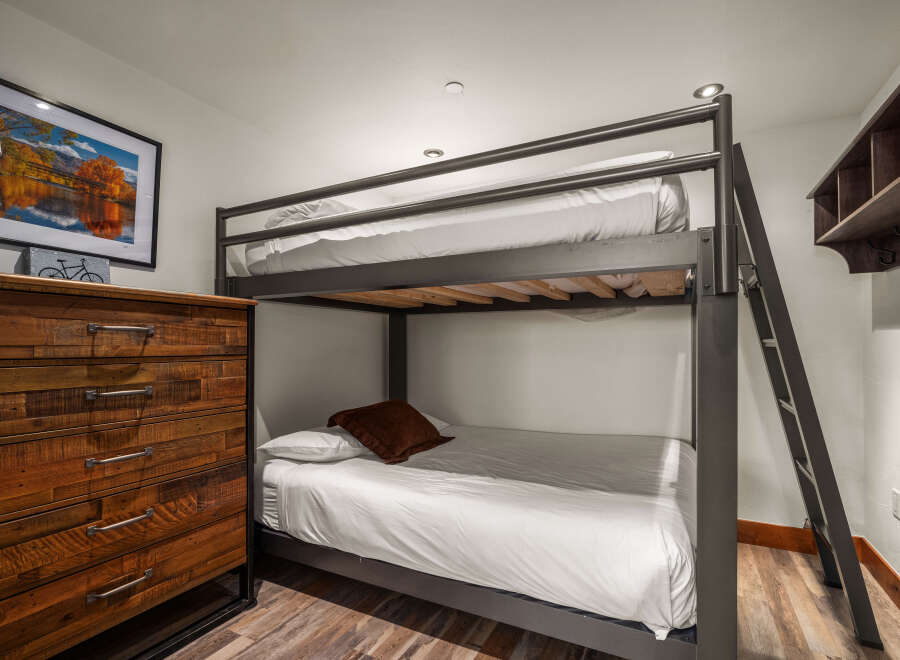 This cozy bedroom features a stylish bunk bed, perfect for accommodating guests or family members.